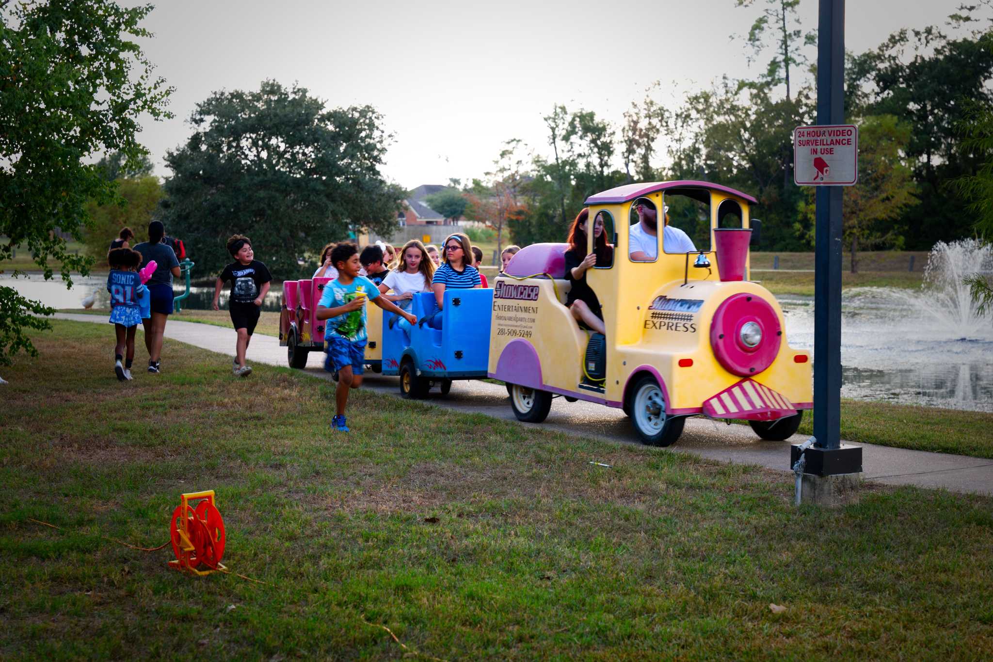 Residents riding a toy train