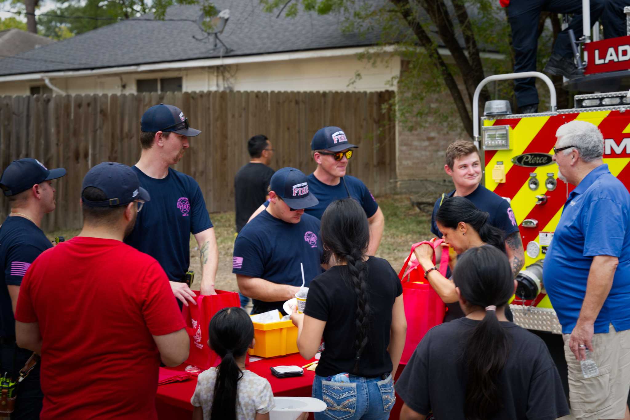South Montgomery Fire Fighters behind a booth with residents